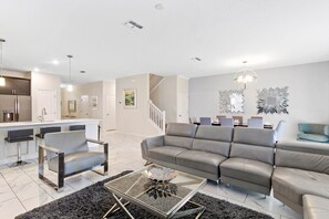 Relax in a contemporary space with a sleek sofa set, stylish bar area, and minimalist design.