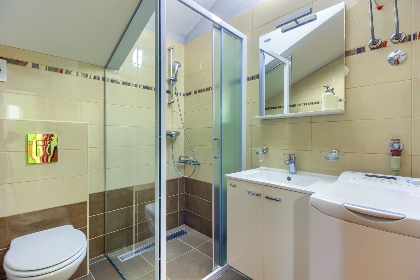 A modern bathroom with a glass-enclosed shower, a white sink, and a toilet.