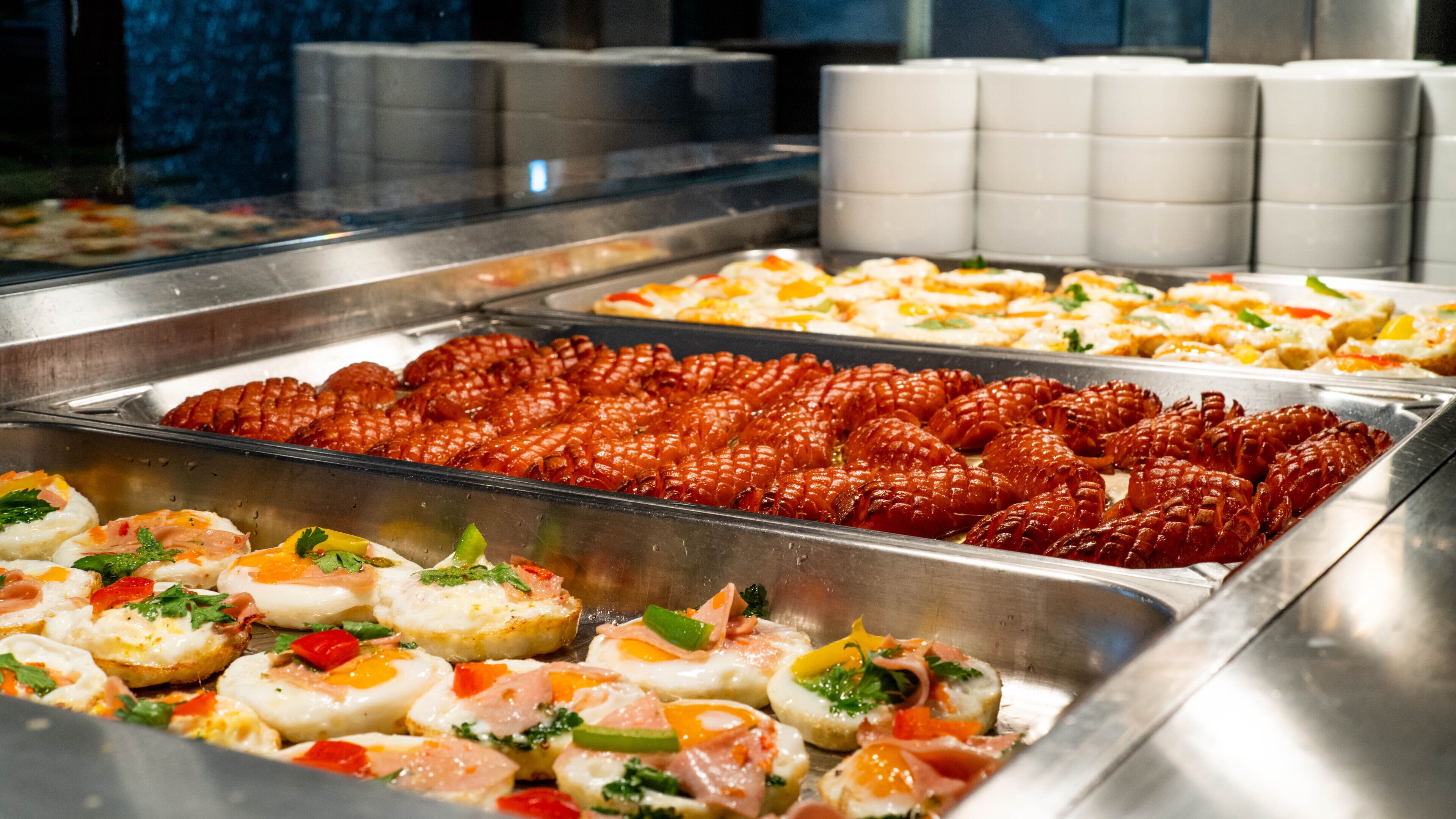 A buffet with various dishes including seafood, eggs, and salads.