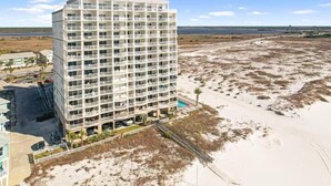 A multi-story hotel with balconies, a pool, and a beach view. - Royal Palms 502 by Liquid Life (Gulf Shores)