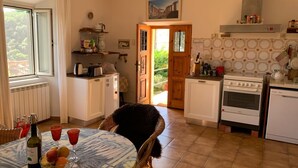 A kitchen with a dining table, chairs, and various appliances. - 2-storey vacation home with 2 large terraces and sensational views (Mazzano Romano)