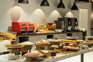 A buffet with various food items and labels, including cold cut ham, Swiss cheese, and mozzarella.