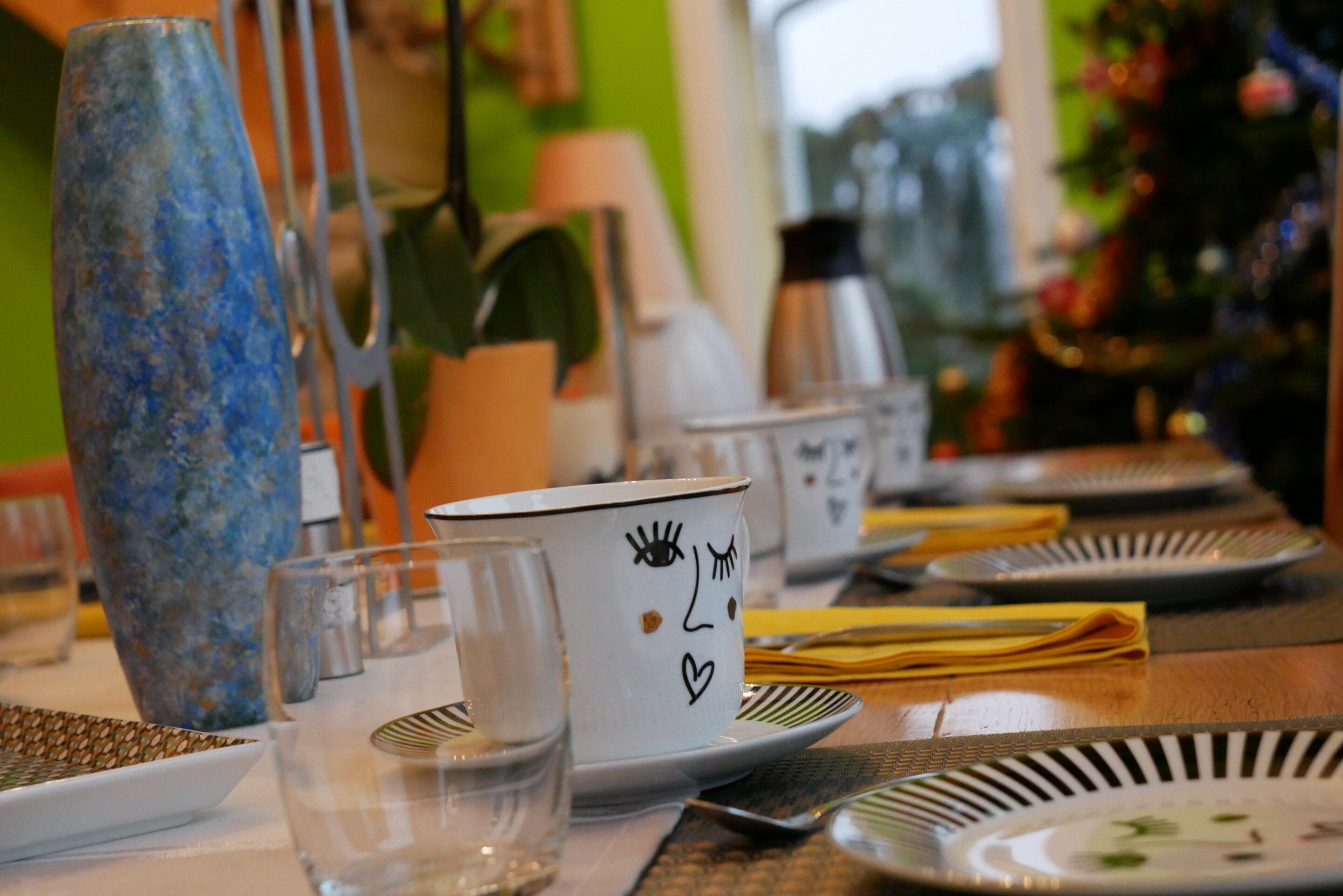 A dining table set with plates, glasses, and cutlery.