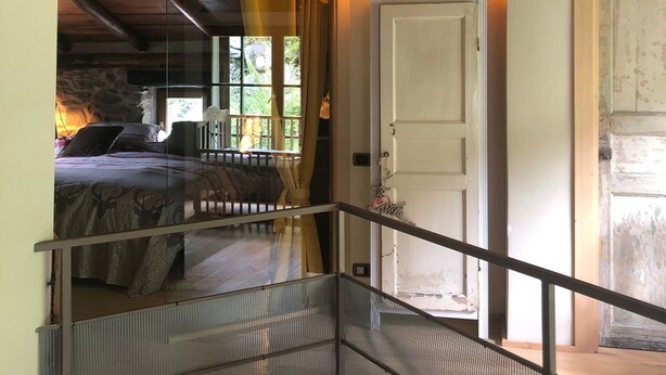 A wooden ceiling with exposed beams, a white door, and a glass railing. - STONE CHALET 6 pers.  ORELLE - SKI VAL THORENS + hiking/m.biking (Orelle)