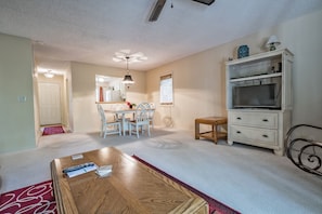 Cozy living space with a dining area, television, and comfortable seating.