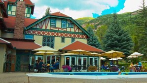 A traditional chalet-style building with outdoor seating and a pool. - Villa On The Boulevard, Redstone's Hidden Gem (Redstone)