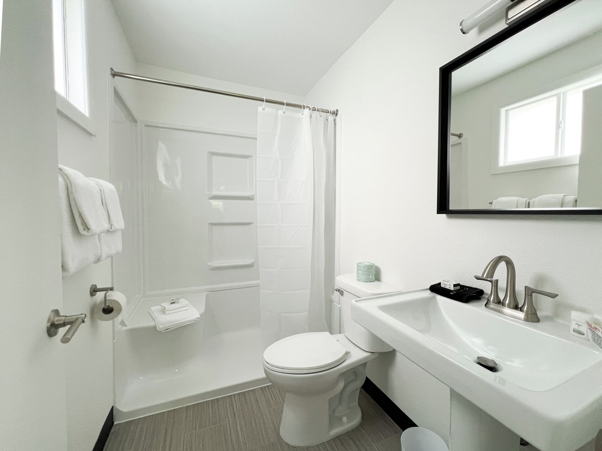 Une salle de bain moderne équipée de toilettes, d’un lavabo et d’une douche.