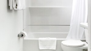 A bathroom with a shower, toilet, and a towel rack.