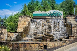 A stone waterfall feature with a sign reading "GOLFVIEW RESORT" in the foreground.
