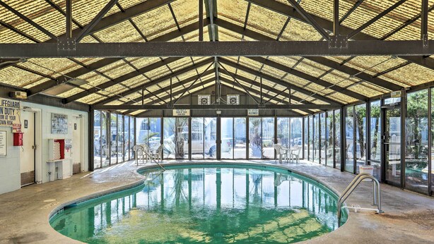 An indoor swimming pool with a covered roof, clear glass walls, and a lifeguard station. - 4 Mi to Cherry Grove Beach: Studio w/ Pool Access (Little River)