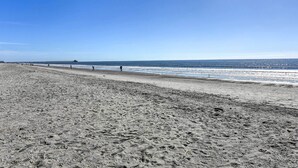 A wide sandy beach with footprints and a pier extending into the water. - 4 Mi to Cherry Grove Beach: Studio w/ Pool Access (Little River)