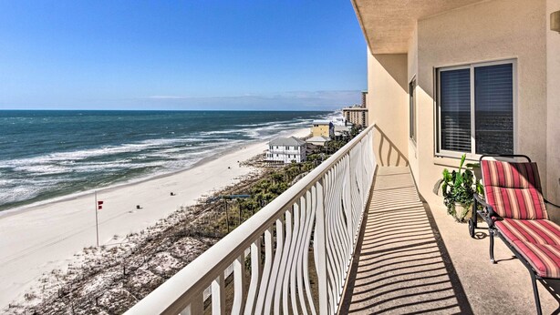 A balcony with a view of the beach, a chair, and a potted plant. - Gulf Views & Pool Access: Coral Reef Resort Condo (Panama City Beach)