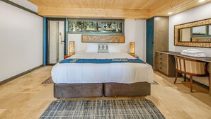 A modern bedroom with a large bed, a wooden ceiling, a desk with a chair, and a large mirror. - Panoramia Villas (Myrtleford)