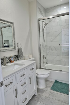 Combined shower/tub, hair dryer, towels, soap