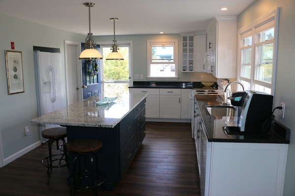 Kitchen with amenities and spacious granite island.