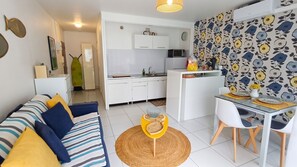 A modern apartment with a living room, dining area, and kitchen.