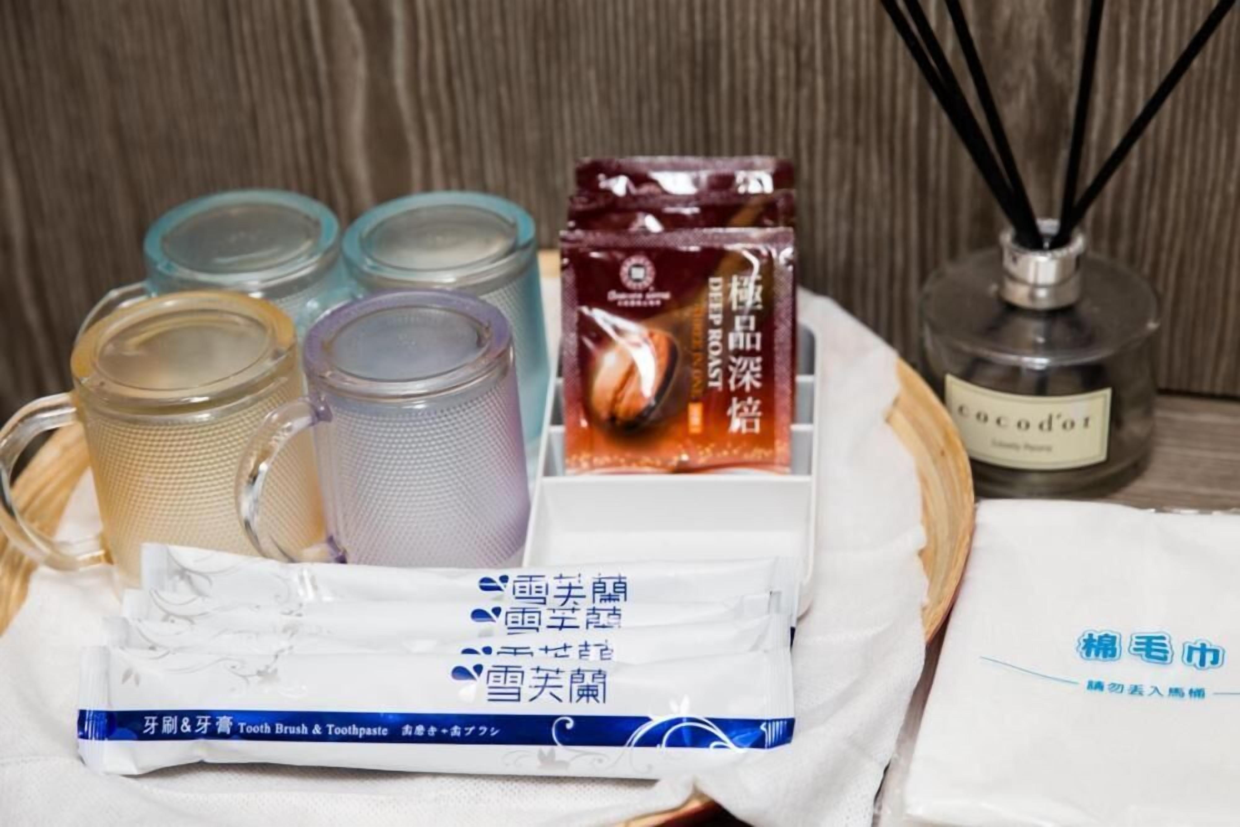 A tray with various toiletries including a toothbrush, toothpaste, and a bottle of hand sanitizer.