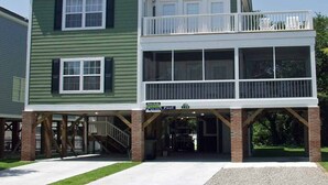 A two-story house with a covered front porch and a balcony on the upper floor. - Bikini Bottom - Walk to Beach in Surfside Beach (Surfside Beach)