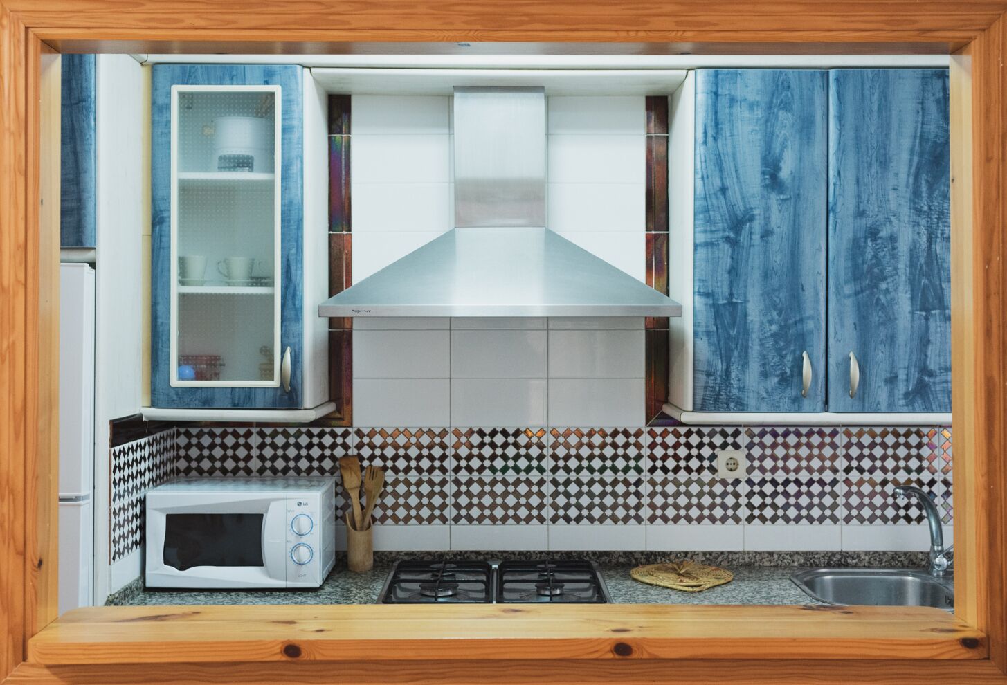 A kitchen with a microwave, stove, and cabinets.