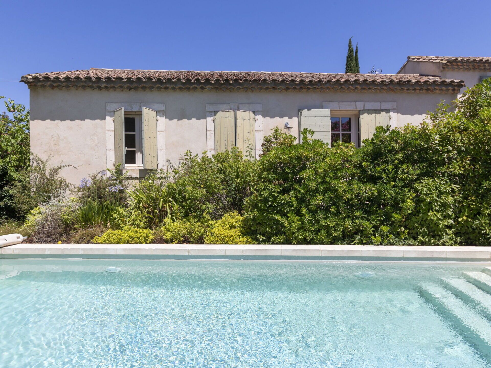 A building with a swimming pool in front.