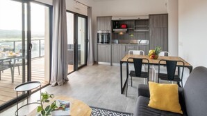 A modern apartment with a balcony, a dining area, and a kitchen. - Château by Interhome (Porto Vecchio)