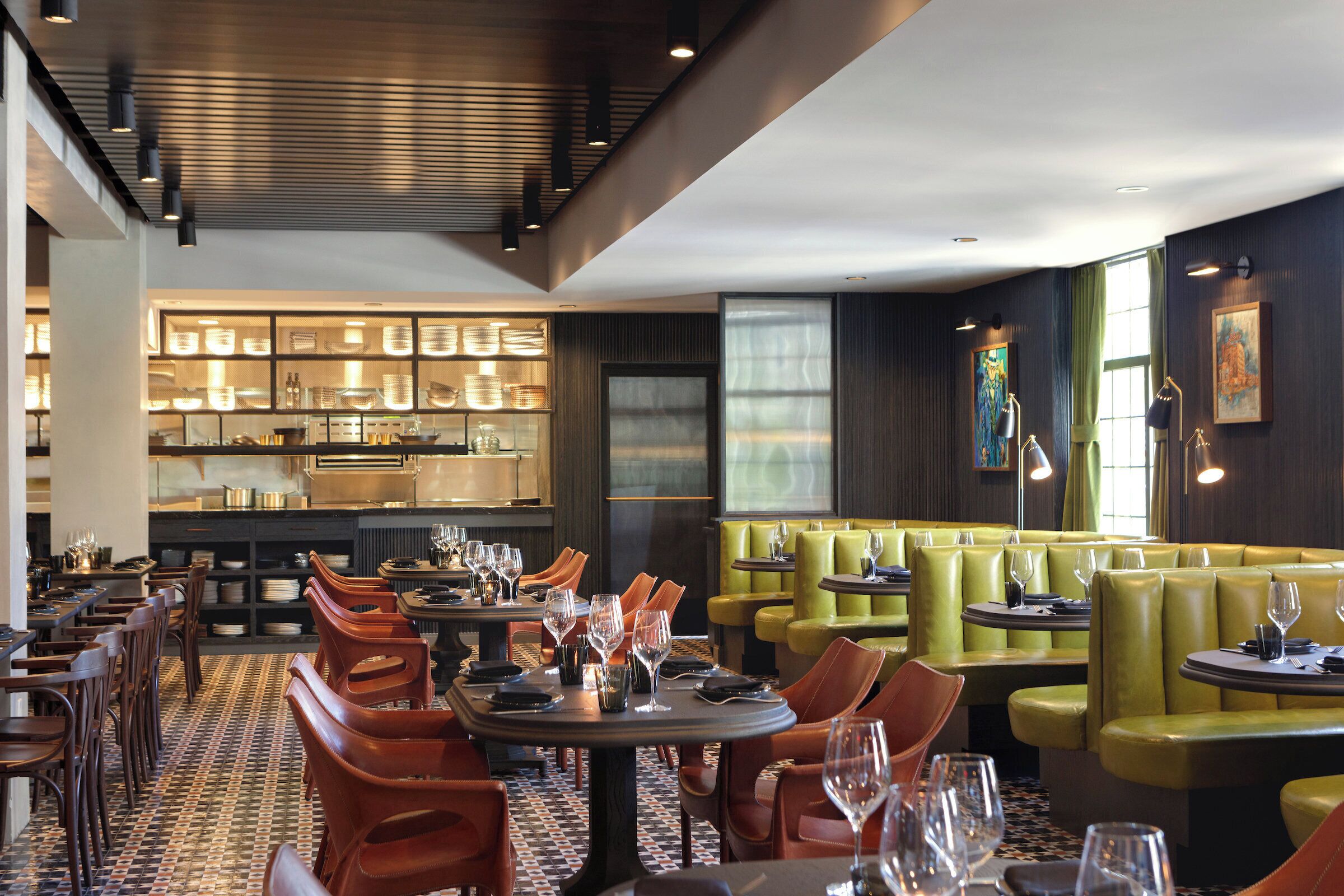 A restaurant interior with booths, tables, and a bar area.