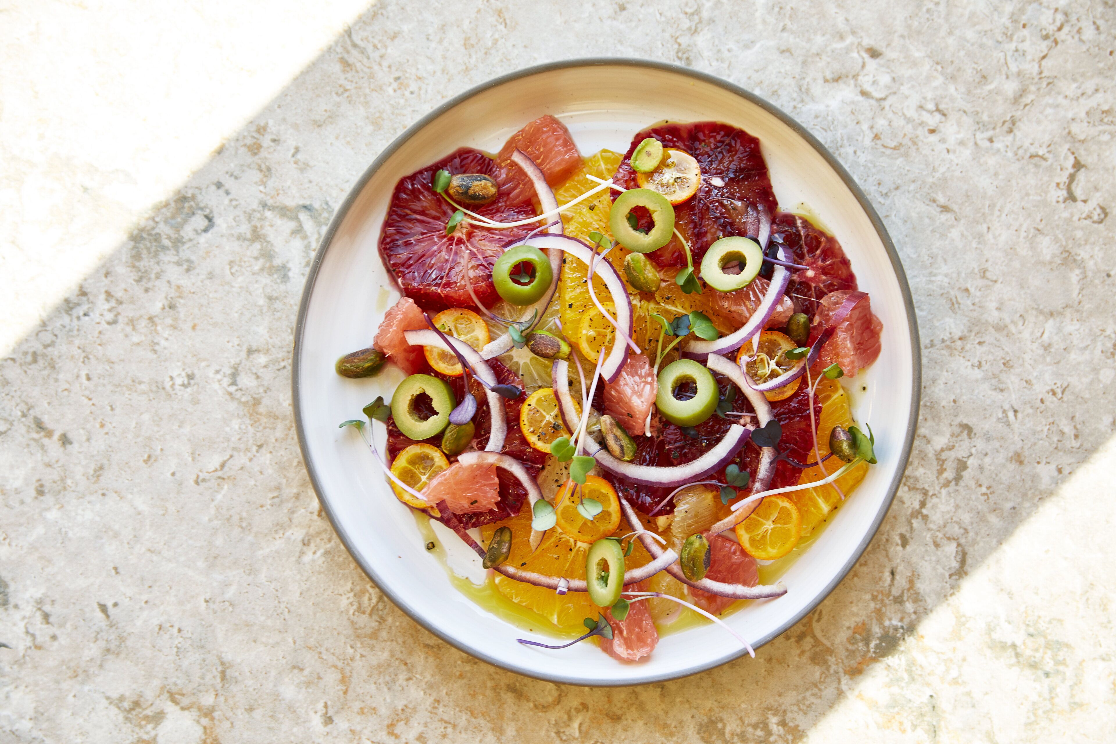 A plate of food with various fruits and vegetables.