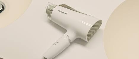 A Panasonic hair dryer on a white countertop.
