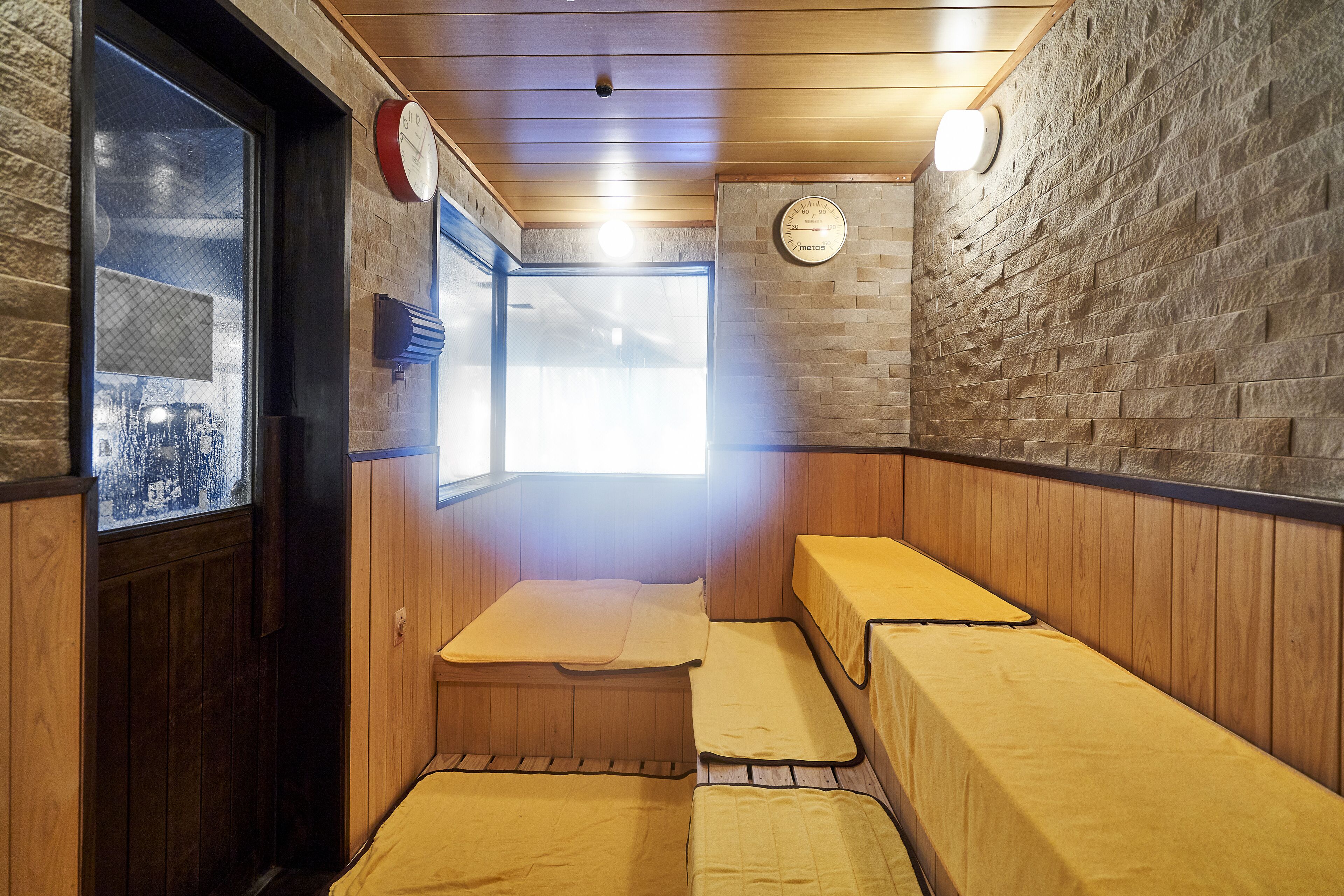 A sauna room with wooden benches and a window.