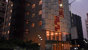 A multi-story building with a modern design, featuring a mix of glass and metal panels. - Lynq Aero (Barasat)