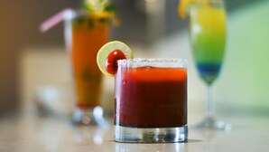 Three cocktails in glasses with garnishes, placed on a reflective surface. - Lynq Aero (Barasat)