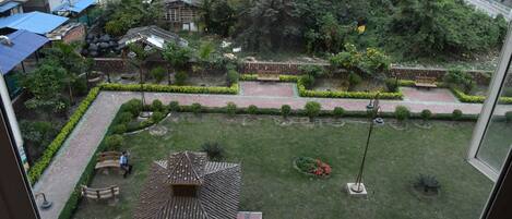 A courtyard with a gazebo, benches, and a small garden area.