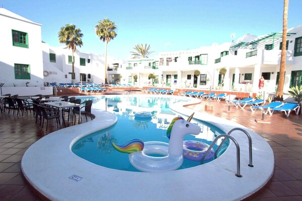 Alberca al aire libre y camastros 