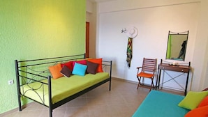 A room with a bed, a desk, and a chair. - Anemi Apartments (Ikaria)