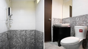 A bathroom with a shower, toilet, and sink.
