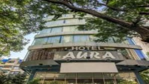 A hotel named "AURA" with a modern design, featuring a prominent glass facade and a signboard. - Hotel Aura (Mumbai)