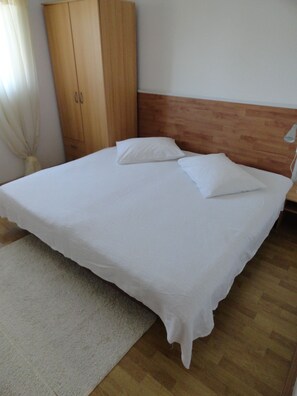 Enjoy a restful stay in this serene hotel room featuring a comfortable bed, spacious wardrobe, and clean design.