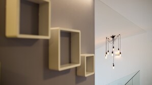 A modern interior with geometric wall designs and a hanging light fixture. - Dandelion boutique hostel (Zadar)
