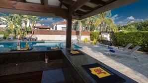 A covered pool area with lounge chairs and a small pool table. - Luxury 4 Bedroom Villa With Private Pool, Sotira Villa 1301 (Sotira)