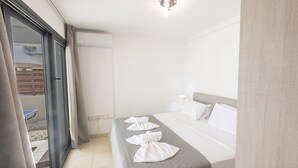 A hotel room with a bed, a window, and an air conditioning unit. - Cyprus Villa Near the Beach, Protaras Villa 1244 (Paralimni)