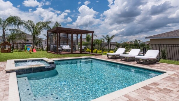 A rectangular swimming pool with a hot tub, surrounded by a brick deck. There are lounge chairs and a gazebo in the background. - Beautiful Villa With Private Pool, Close to Disney, Orlando Villa 2942 (Kissimmee)