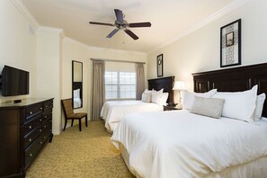 A hotel room with two beds, a television, a dresser, a ceiling fan, and a window with blinds. - Luxury 3 Bedroom Condo on Reunion Resort, Orlando Condo 3501 (Kissimmee)