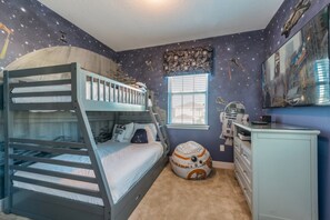 A room with bunk beds, a Star Wars-themed wall, a window, and a Star Wars-themed bean bag. - Villa in Encore Resort at Reunion 3438 (Kissimmee)