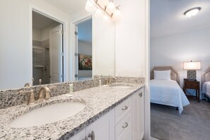 A hotel bathroom with a double sink, a large mirror, and a shower area. - Beautiful Mansion With Private Pool, Close to Disney, Orlando Mansion 2889 (Kissimmee)