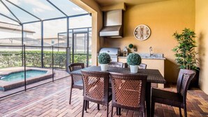 An outdoor patio with wicker furniture, a grill, a sink, and a small pool. - Beautiful Villa With Private Pool, Close to Disney, Orlando Villa 2641 (Kissimmee)