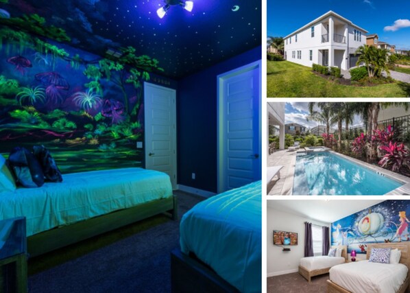 A bedroom with a starry night mural, a bed, and a door.