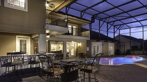 A covered outdoor area with a pool, dining tables, and chairs. - Luxury 9 Bedroom Villa on Osceola County, Orlando Villa 3569 (Kissimmee)