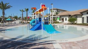 A water park with a blue slide and a pool.