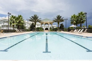A swimming pool with lounge chairs and a gazebo in the background. - Luxury 3 Bedroom Condo on Reunion Resort, Orlando Condo 3483 (Kissimmee)