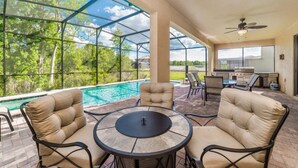 A covered outdoor area with a pool, seating, and a grill. - Beautiful Villa With Private Pool, Close to Disney, Orlando Villa 1835 (Kissimmee)